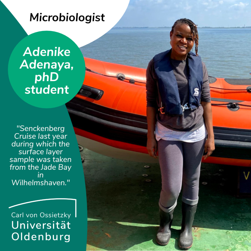 An Interview with Adenike Adenaya, a microbiologist and phD student. Here she is shown on a Senckenberg Cruise last year during which the sea surface micro-layer samples were taken from the Jade Bay in Wilhelmshaven. Tags nikkytville. On the picture you can see Adenike Adenaya, a Black person with dark hair. She is smiling and wearing a life jacket and rubber boots. She is standing in front of the sea on a sunny day. Behind her is an orange dinghy. 