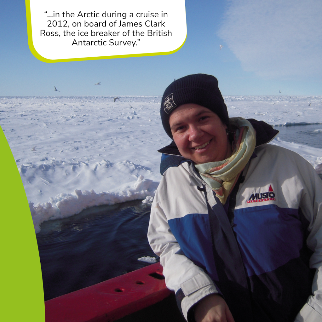 On this slide is another picture. It contains a  person leaning against the rehling of a ship who is wearing a black hat, a colorful scarf and an anorak in blue and white. In the background is the sea and sheets of ice. The text in the green and white box says: „“…in the Arctic during a cruise in 2012, on board of James Clark Ross, the ice breaker of the British Antarctic Survey.”